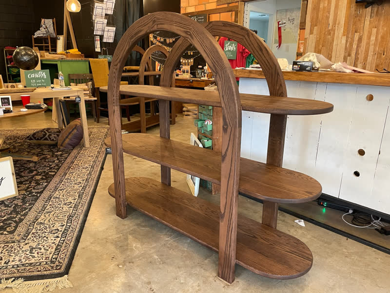 Arched oak display shelves with rounded tiers, built for the retail floor