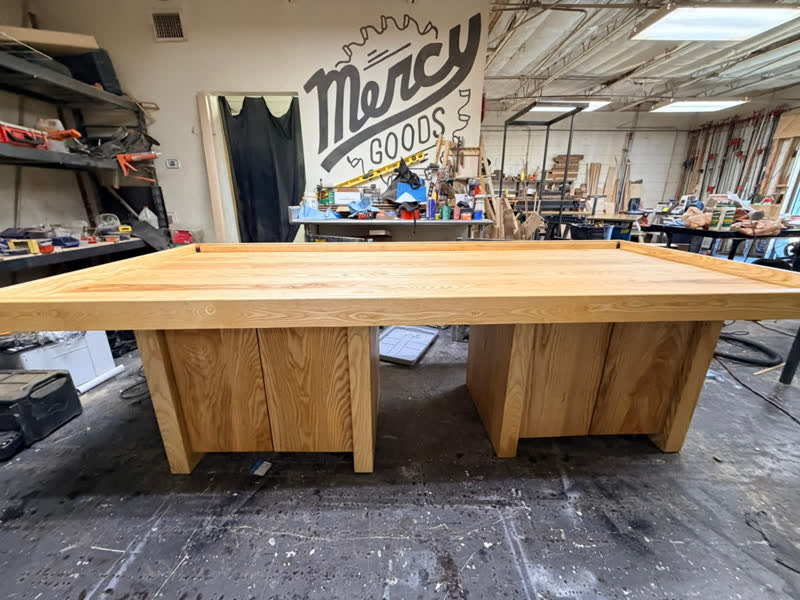 A large bar-height table with cabinet bases, fresh from the workshop floor