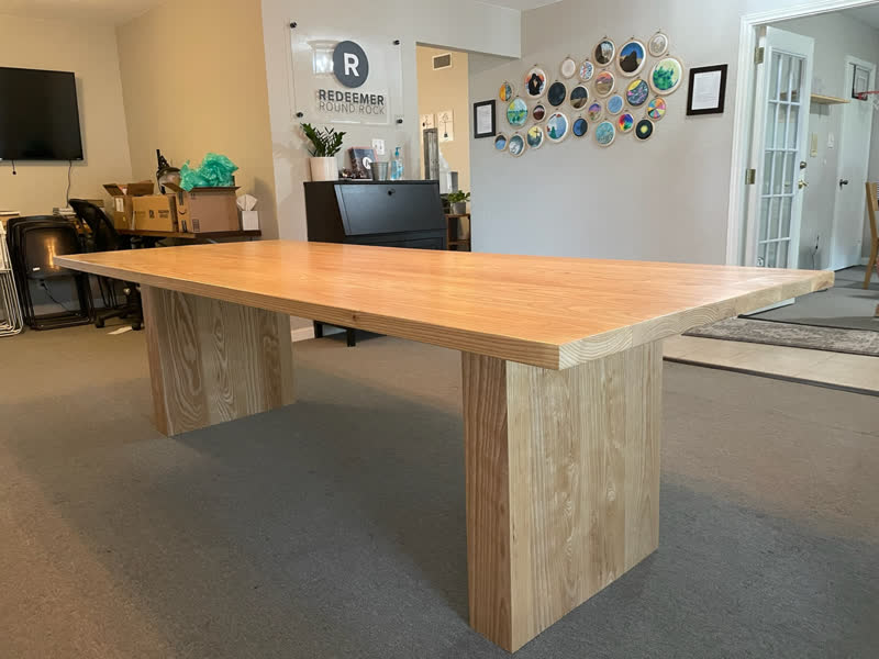 A long ash table with solid block pedestals, delivered to a church meeting room