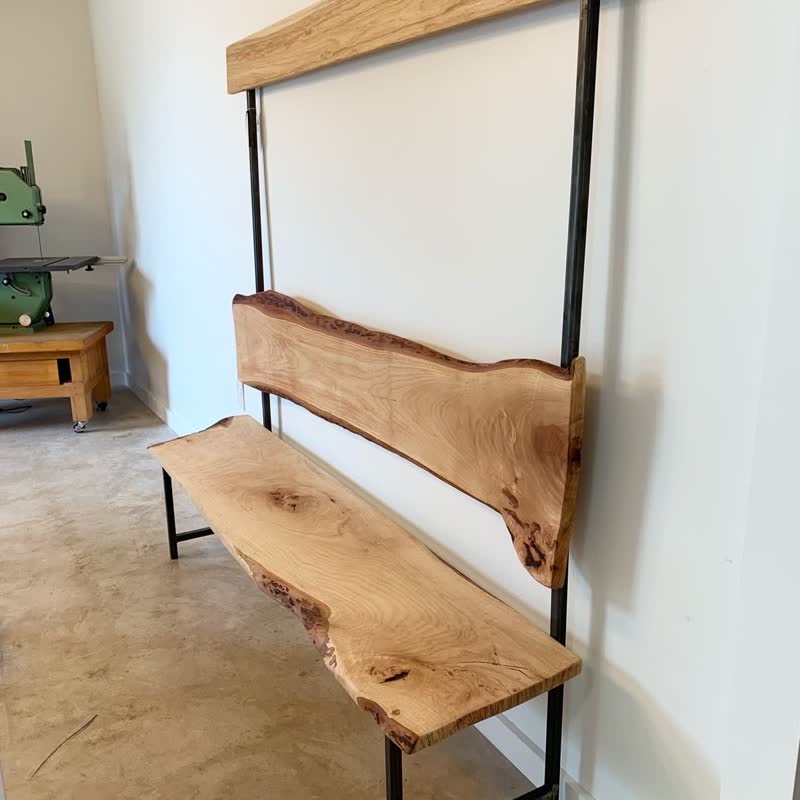 A live-edge bench with a steel frame in the Mercy Goods workshop