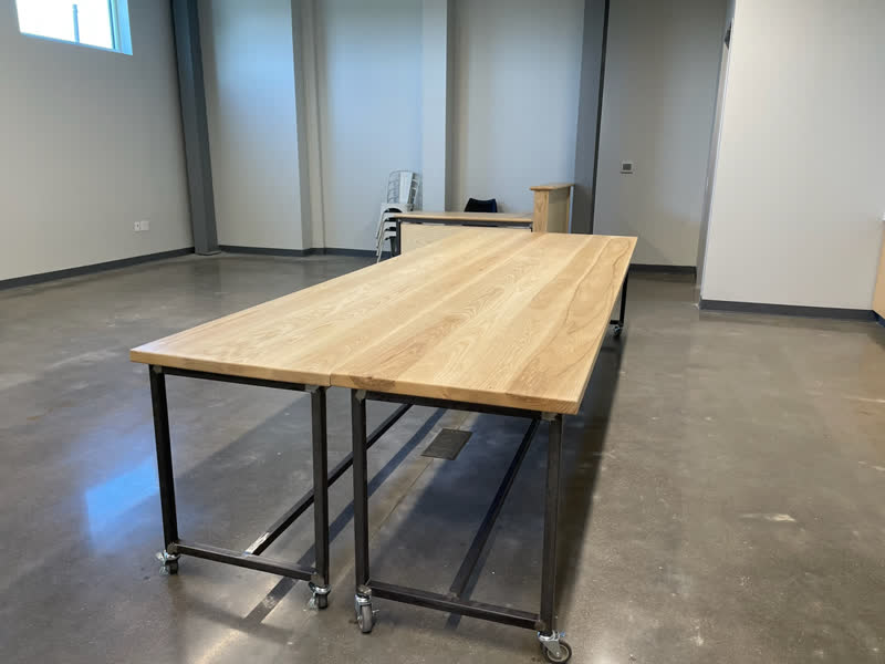 Two oak work tables on steel frames with casters, built for a client's meeting space