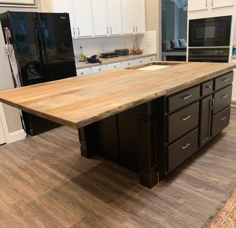 A live-edge countertop built by students, installed on a client's kitchen island