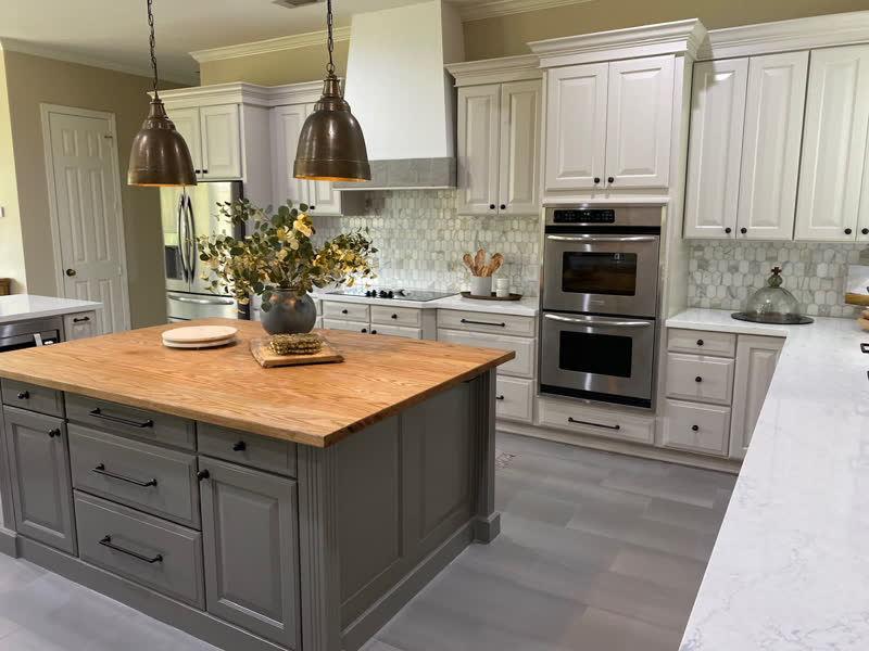 An oak butcher-block island countertop installed in a client's white kitchen