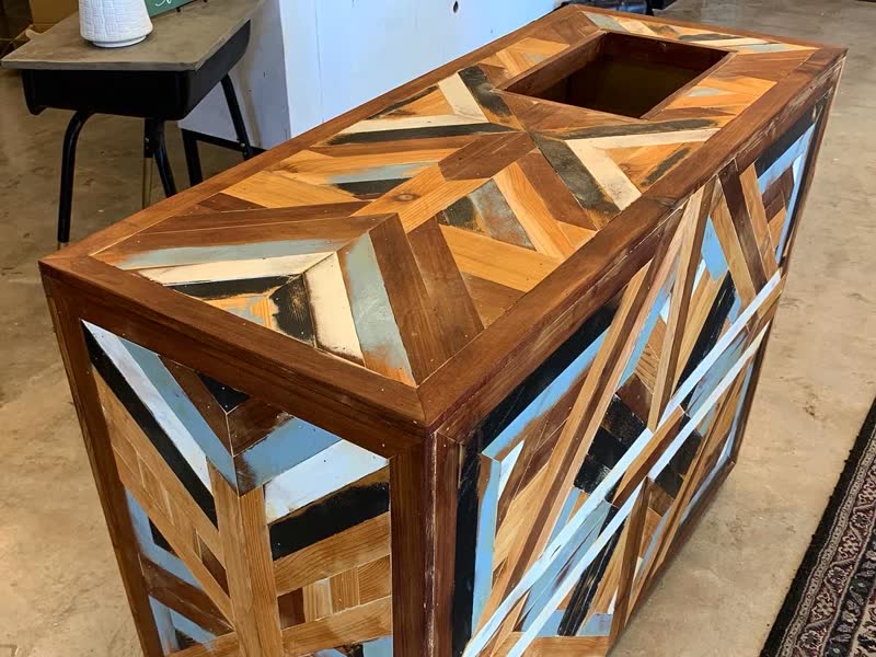 A mosaic cabinet built from reclaimed scrap wood