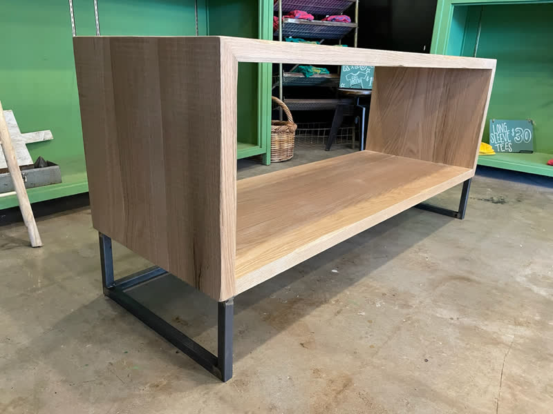 A low oak console table with a steel base, built in the Mercy Goods workshop