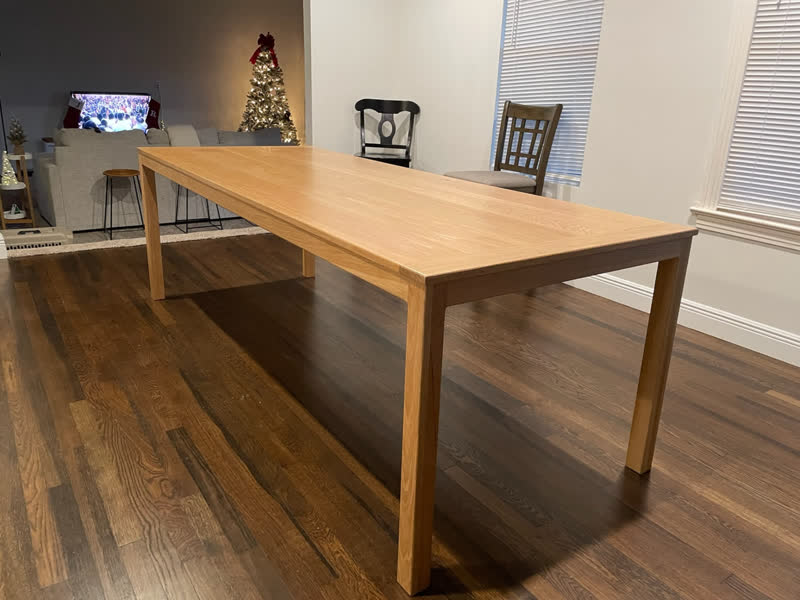 A white oak dining table with tapered legs, delivered to a family's home