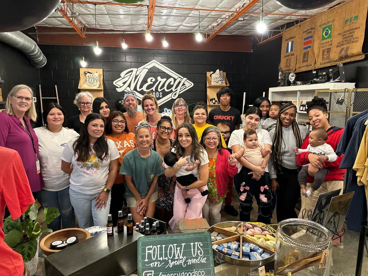 Young parents with their babies gathered at the Mercy Goods shop